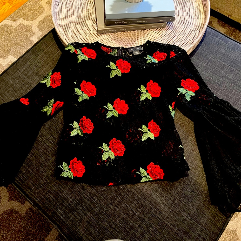 Beautiful black lace with red roses blouse. Blouse has wide 1/4 sleeve.